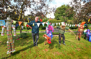 Looking at pots in the theme of Wizard of Oz, at Boughey Road, Newport, borough council ward member Peter Scott