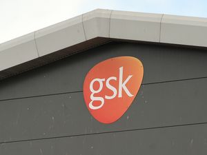 The side of a large warehouse, with a GSK sign on it
