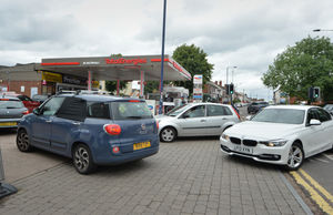 People queue to buy fuel at reduced price, at TotalEnergies Blakenhall Service Station, Dudley Road, Wolverhampton