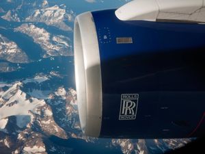 View of a Rolls Royce engine for British Airways from the plane as it flies over the snow capped mountains of Greenland