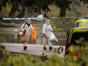 Forensic officers near the lake inside West Park
