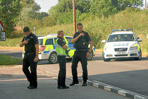 Police close the road after the Corsa and the Ford Focus collide