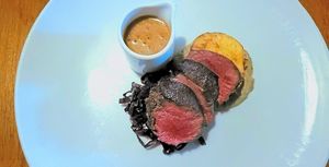 A main course of delightfully pink, succulent venison, celeriac and pepper sauce