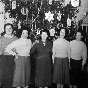 Staff at the Grand cinema, Wellington, in 1959. The page in the scrapbook gives the caption: 'Grand Theatre, Wellington. Pat Turner, Pat Chatham, Anne Weaver (manageress), Hilda Jones, Elsie Royale.' Also the 1959 date. Obviously it must have been around Christmas given the decorations in the background. This picture is from Mrs Lynne Purcell, and is from the collection of her late father Fred Brown, who came from Wellington and was a historian of Wellington. On leaving school at 14 in 1937 he was an assistant projectionist at the Regal cinema at Hadley, and then was projectionist at the Clifton cinema in Wellington from 1938 for 24 years. Later he was projectionist at the Grand Theatre in Wellington until it closed down. 