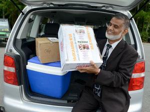 Chef Mofur Miah with the curries in the boot of his car at the golf club