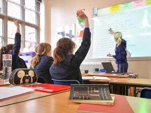 A pupil and teacher in a classroom