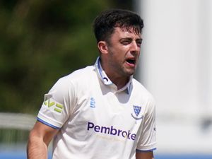 Tom Haines celebrates taking a wicket for Sussex