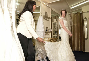 Lauren Gillies, 29, from Moseley, trying on wedding dresses with shop owner Jo Parker