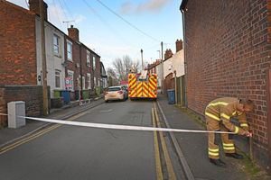 Fire investigators cordoning off the road