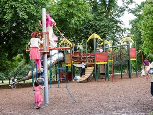 Children playing on a climbing frame in a children's playground