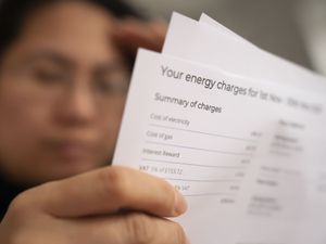 A person holding an energy bill