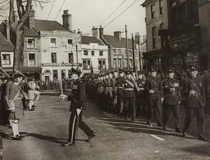 South Staffordshire Regiment, Bilston. A detachment marched through to mark the 250th anniversary of the foundation of the regiment. The photograph shows them turning their eyes right to Bilston Town Hall, and includes the premises of Lloyds Bank and Timonty Whites & Taylors. April 7, 1955.