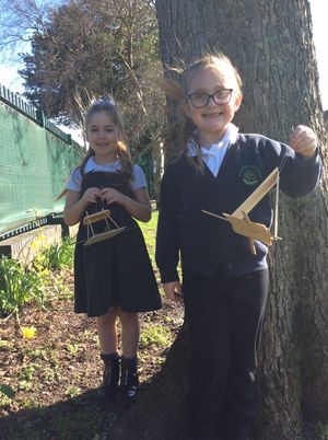 Pupils preparing to hang their birdfeeders.