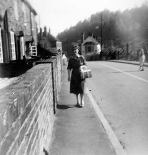 Gertie Millward walking past Carpenters Row