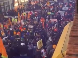 Supporting image for story: 'Leave the area as soon as possible': Police plea as hundreds gather for international protest rally - with smoke devices set off and long delays caused