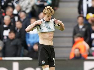 Newcastle’s Anthony Gordon leaves the pitch after being shown a red card by referee Anthony Taylor