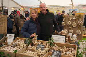 Chris and Nicky Duffy from Nanthelyg Farm in Cwmdu with their garlic grown in Wales. Their garlic recently won a best in show special mention at the Abergavenny Food Festival and they were also selling grinders, presses, pestle and mortar and dried garlic. Image by Andy Compton