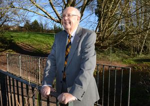 John Pike stands on the bridge over the Wom Brook