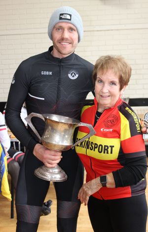 Dean Callister receives a trophy from Rita Taylor