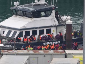 A group of people disembark from a Border Force vessel after a small boat incident in the Channel