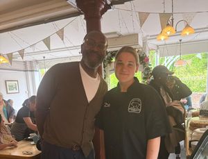 Lenny Henry with staff at Truffles Café in Ironbridge.