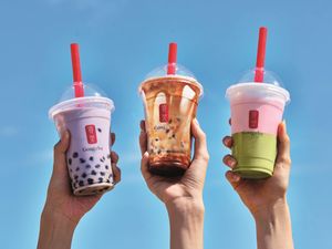 Three hands holding up Gong Cha bubble teas