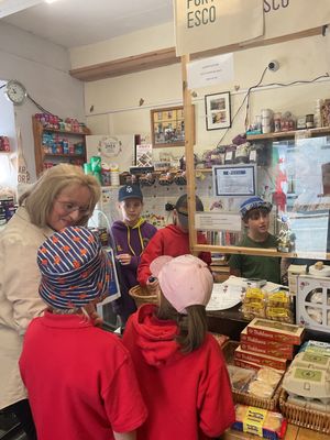 Criw Cymraeg members of Radnor Valley School (Ysgol Dyffryn Maesyfed) photographed with Chair of School Govenors, Mrs Jane Donald, supporting the shopping through the medium of Welsh