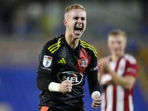 Exeter City goalkeeper Joe Whitworth celebrates in front of the fans after the Sky Bet League One match at The Croud Meadow stadium, Shrewsbury