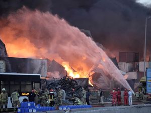 Firefighters tackle the blaze after a huge explosion at a port near Bandar Abbas in southern Iran