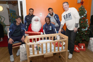 Father Christmas delivers presents to Deakin Johnson with the help of Kieran Gibbs, Darnell Furlong, Romaine Sawyers and Kyle Bartley. Photo: AMA
