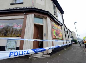 Police at the corner of Walpole Street and New Hampton Road East, as part of the investigation.
