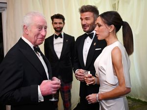 The King speaks to Davidand Victoria Beckham