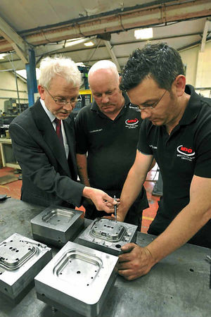 MPD technical sales managerJohn Oakley discussing a die with Keith and Jason Clarke