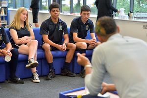 The students listen to the Olympic star