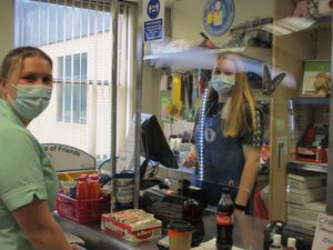  Young volunteer Charlotte Hope, 17, serving a member of the hospital staff in one of the League of Friends shops