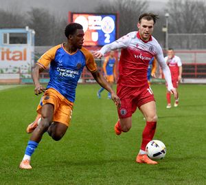 Kevin Berkoe beats Accrington's Alex Henderson. Picture: Tim Thursfield