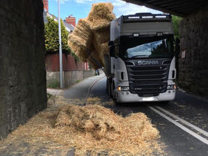 Supporting image for story: Road shut after lorry hits bridge and sheds its load of straw

 