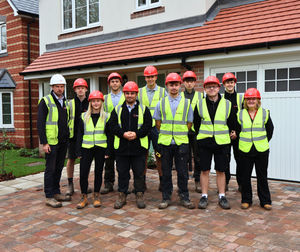 Matthew Roberts and Annette Harrison, of SJ Roberts Construction, with some of the 2024 intake of apprentices 
