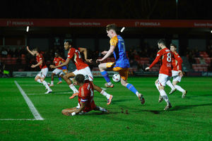 Tommy McDermott looks to skip past a Salford defender