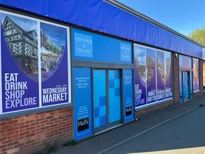 Banners promote Market Drayton and things to do and see in the town as well as estate agents Halls who are offering the property. 