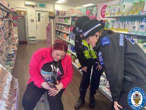 Officers talk to shop staff