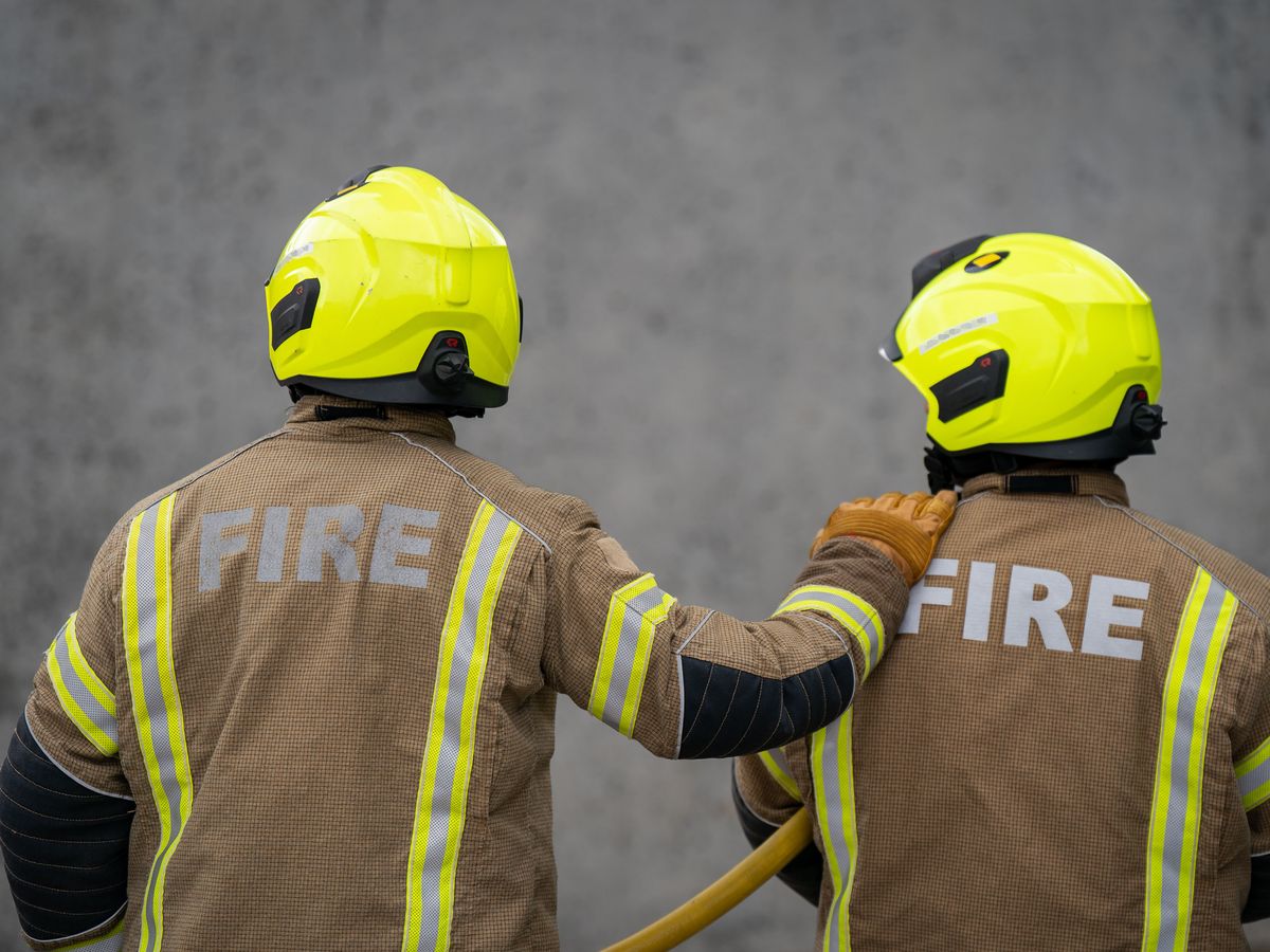 Firefighters battle blaze at shop and flats with people evacuated nearby
