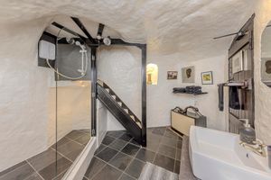 A stunning 16th-century West Midlands cottage built into a carved-out cave has gone on sale .