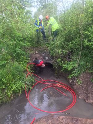 Bryn Jones begins work watched by volunteers from the canal trust