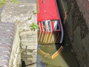 Supporting image for story: Three elderly people rescued from sinking narrowboat in canal lock