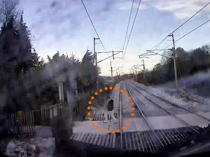 Supporting image for story: Heart-stopping video shows moment man narrowly avoids being killed by express train
