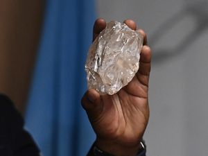 A person holds a 2,492-carat diamond which was found in Botswana