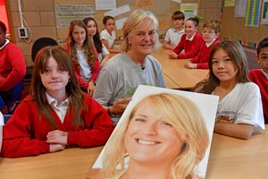 Jane Mackenzie, centre, with students and a photo of her daughter Amy at Martin Wilson Primary School