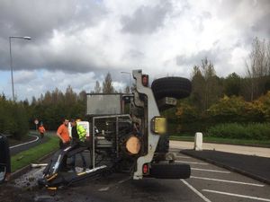 Supporting image for story: Digger crashes onto side in Telford