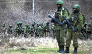 Soldiers carrying guns stand guard in the Ukraine